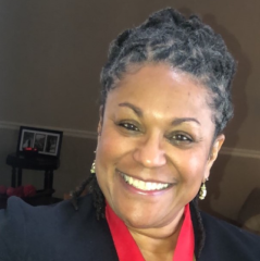Renee Cunningham-Williams headshot - dark-skinned woman, smiling, dark gray hair, red shirt, black blazer, earrings